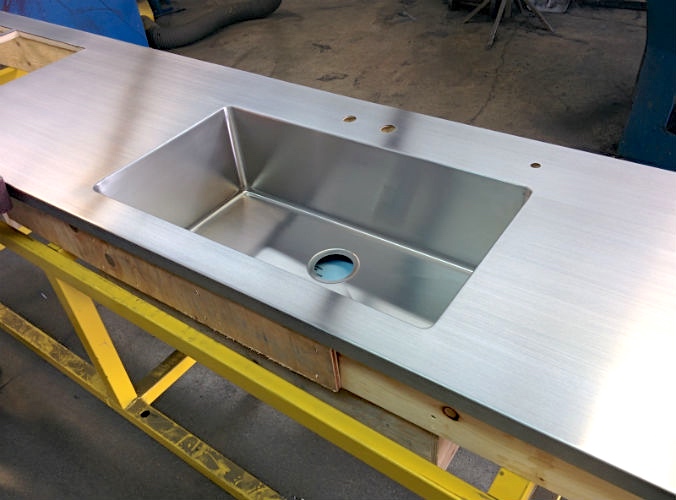 Stainless steel counter with integrated sink